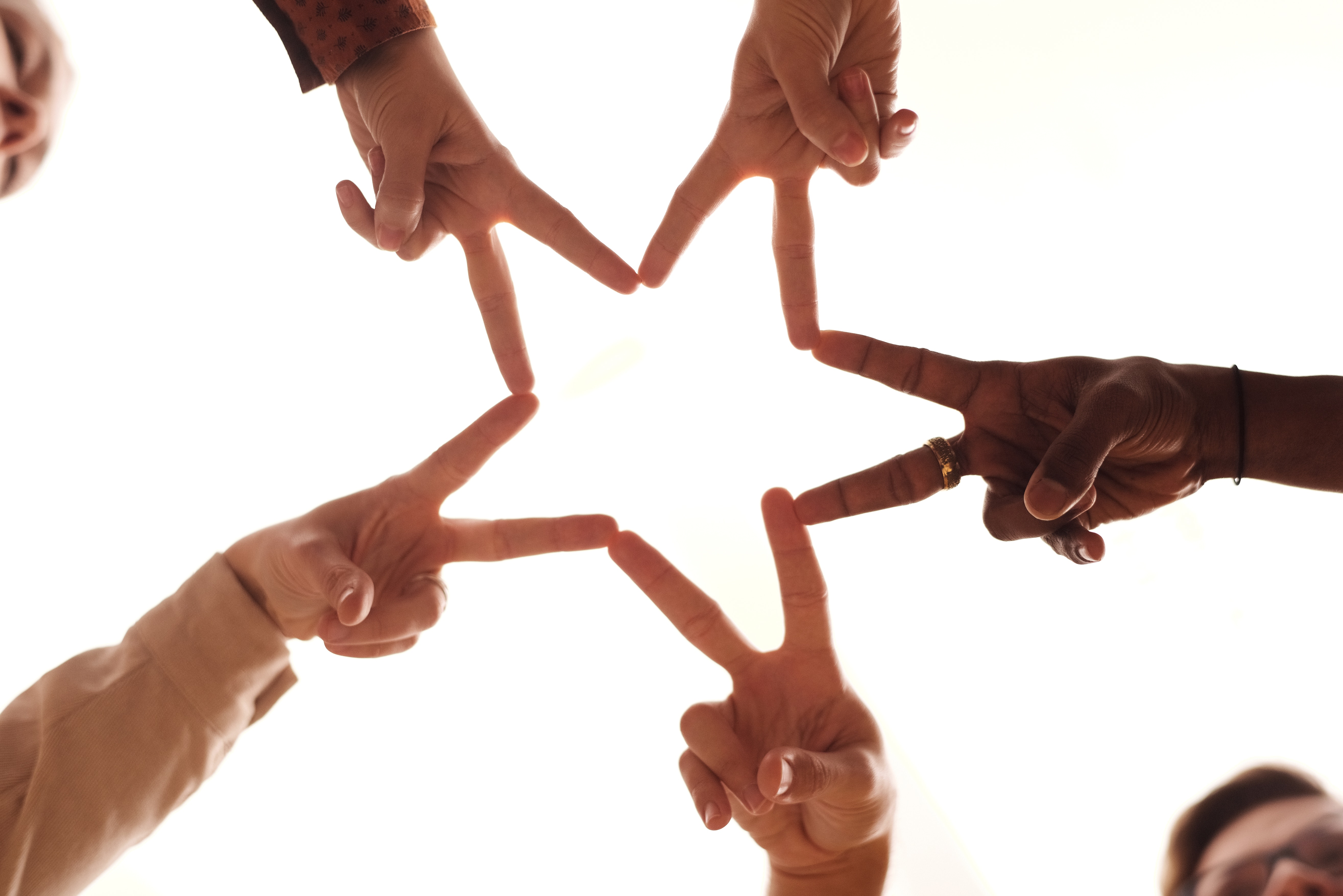 Five different hands arranged in a star shape